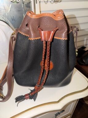 Dooney & Bourke Black Pebbled Leather Drawstring Bucket Bag with Brown Trim